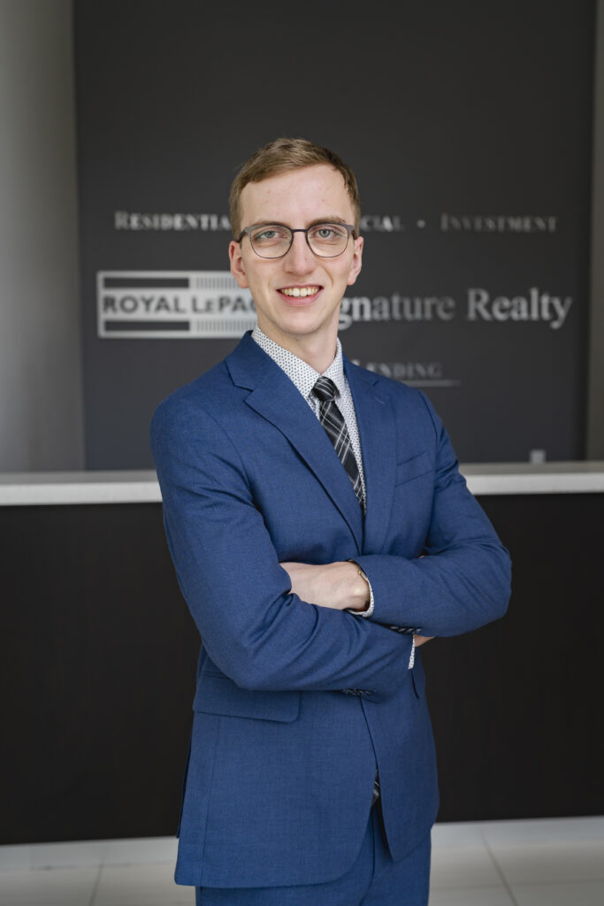 Oliver in front of real estate company front desk